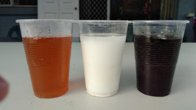 Three cups of water with contaminants
