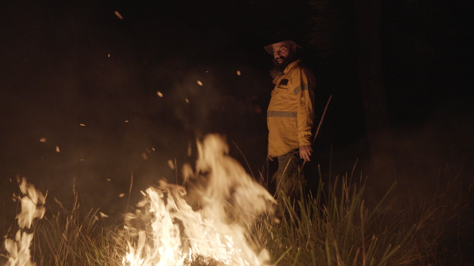 An Aboriginal ranger burning dry grass